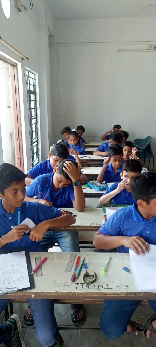 Children learning abacus in classroom